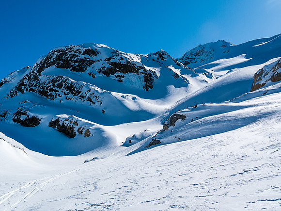 Looking back up the terrain at TJ who's waiting his turn to ski down through the tightening terrain.
