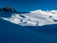 Ben and TJ are skiing quickly back down to the hut.
