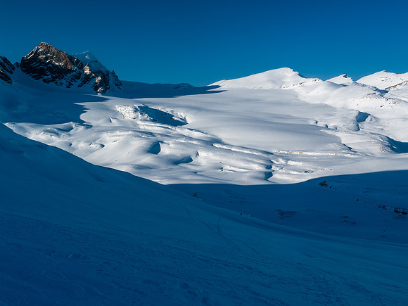 Ben and TJ are skiing quickly back down to the hut.