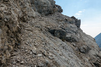 Traversing scree benches and ledges to the SE ridge along the upper south face. Note the window?
