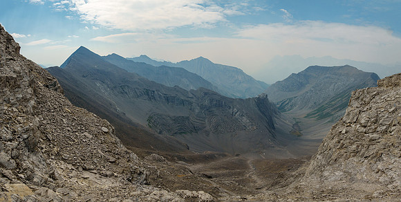 Traversing scree benches and ledges to the SE ridge along the upper south face.