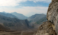Traversing scree benches and ledges to the SE ridge along the upper south face.