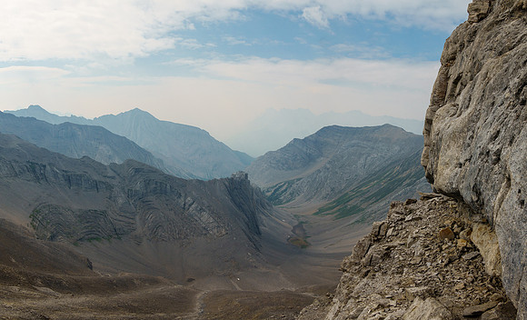 Traversing scree benches and ledges to the SE ridge along the upper south face.