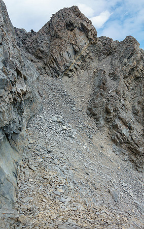 Steep scree and rubble to the summit at left.