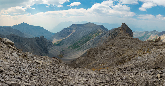 Traversing ledges back to the south face gully just ahead at center.