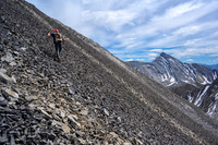 Hiking up the scree bench to the SE ridge.