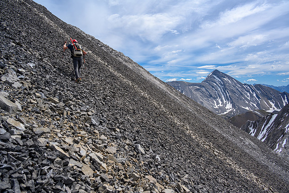 Hiking up the scree bench to the SE ridge.