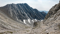 Descending slab and rubble along the sloping bench.