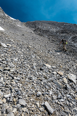 Scrambling easy to moderate ledges and rock ribs to the summit high above.