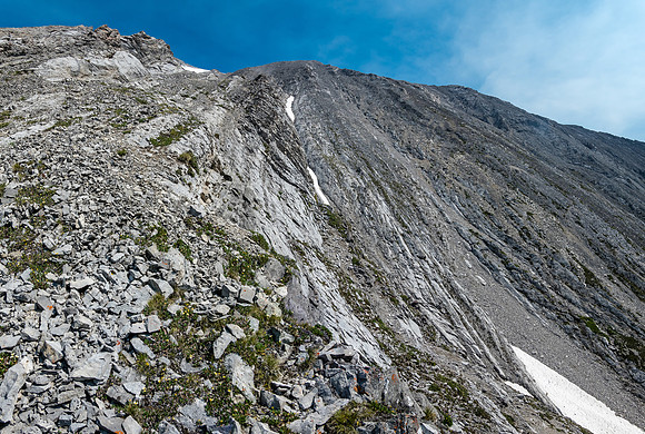 Scrambling easy to moderate ledges and rock ribs to the summit high above.