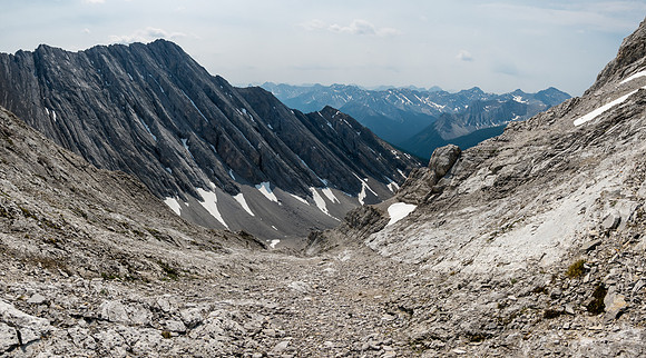 Descending slab and rubble along the sloping bench.