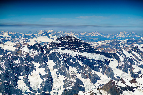 Gazing far off to the west over the dark triangular east face of Cockscomb Mountain towards the Selkirk Mountain Range.