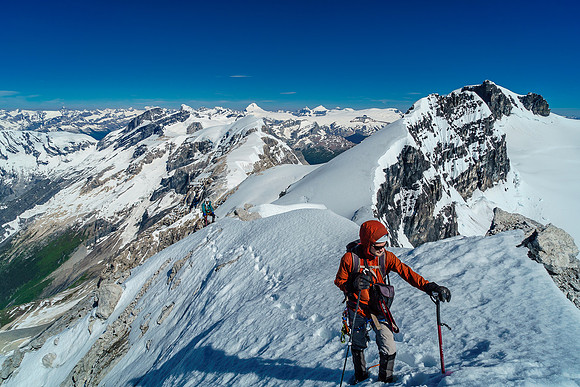 Ben on the summit with our tracks leading to the traverse and Steven returning behind him.