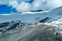 Ben takes photos as we traverse a rock rib along the small tarns which are out of sight to the right here.