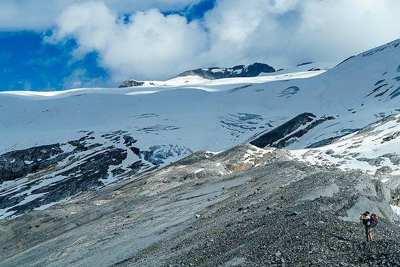 Ben takes photos as we traverse a rock rib along the small tarns which are out of sight to the right here.