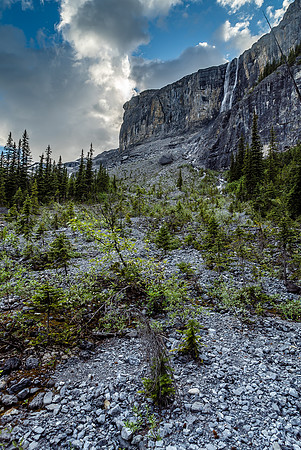 A glimpse upwards to the towering cliffs above on the right and a "twin" falls.