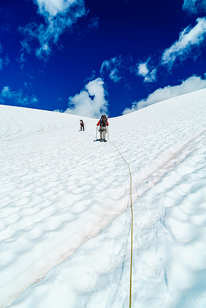 It's a bright world ahead of us as we slog up the initial steep roll at the toe of the icefield.