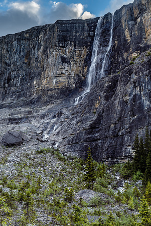 A glimpse upwards to the towering cliffs above on the right and a "twin" falls.