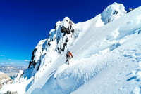 Ben finishes the delicate traverse over the 'schrund on Ernest Peak's NE face - Steven boot belays from above.