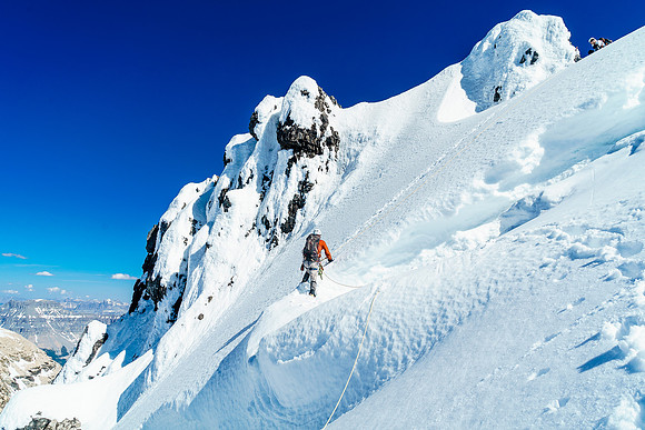 Ben finishes the delicate traverse over the 'schrund on Ernest Peak's NE face - Steven boot belays from above.