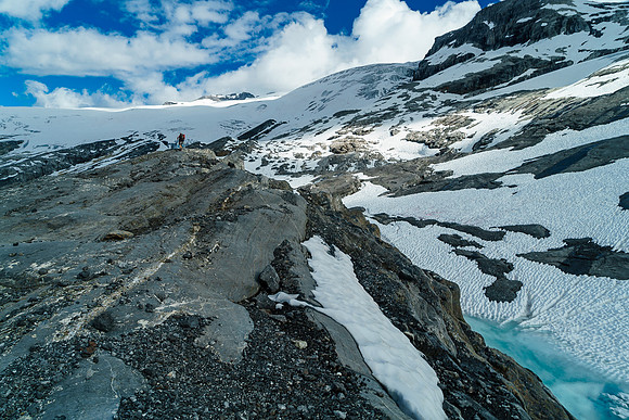 Ben hikes beside the first tarn - just visible at lower right. Note we are high above slabs to our right and heading directly to the glacier now.