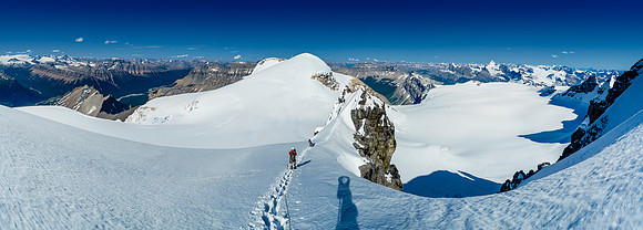 Hiking back to the crux on the NE face along the east ridge with spectacular views over our next two summits and down the icefield below.