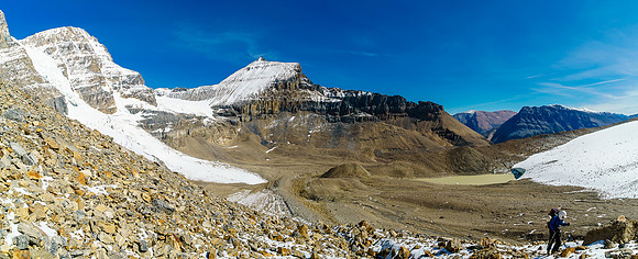 Steven comes up the moraine behind me with Mushroom Peak towering over him.
