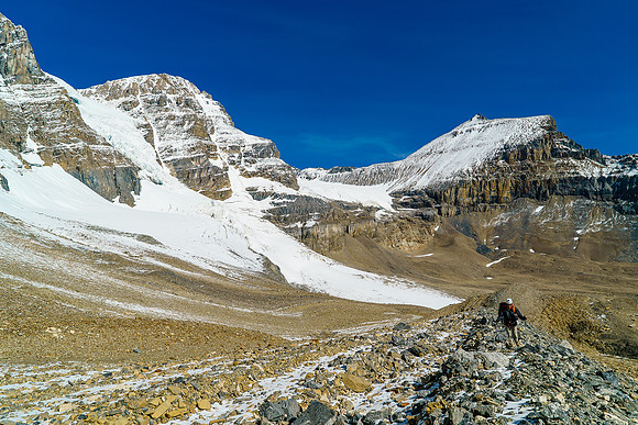 Ben comes up the moraine behind me with Mushroom Peak towering over him.