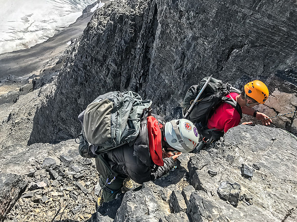 Rigging a mid gully rap station as Ferenc pulls the rope from the upper one.