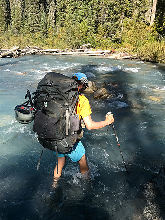 Ben wades into the very benign creek.