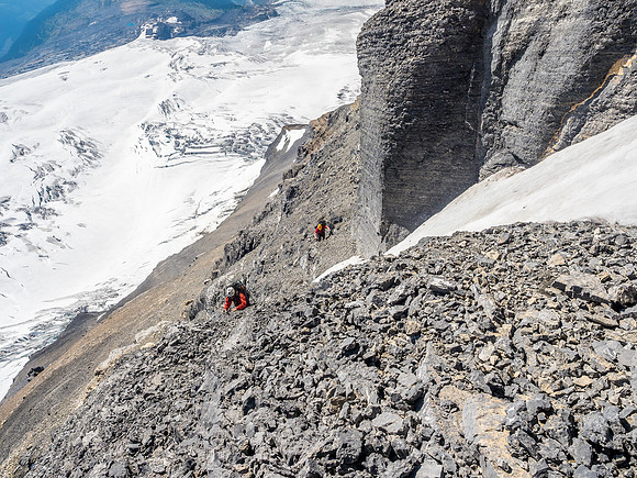 Ben and Ferenc follow me across a narrow, icy couloir and up the loose rock to climber's right of it.