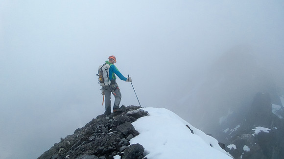 Vern climbs on in the clouds - photo by Steven Song.