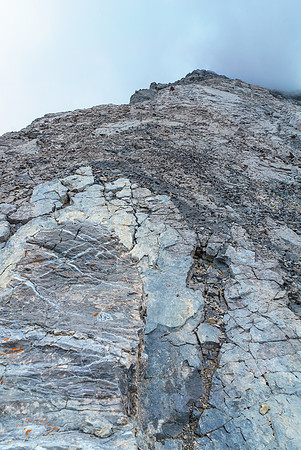 Ben follows down the slabby ridge.