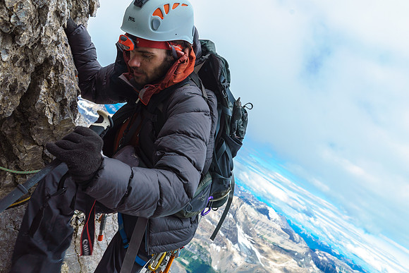 Ben takes care on the loose ridge. Note the tat we're climbing around.