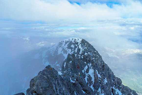 Looking back at Steven and Ben as they do the exposed traverse around the pinnacles on the summit ridge.