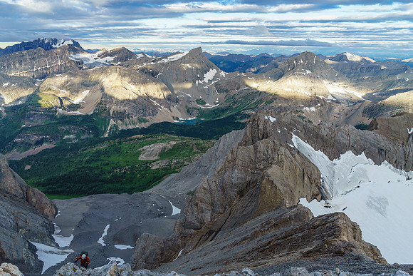 Ben comes back to the west ridge with incredible views opening up behind us.