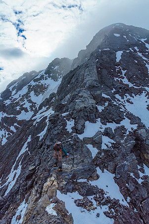 The false summit rises above us in the swirling clouds, the true summit at upper left.