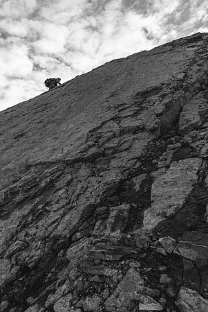 Steven works his way up a steep slab section
