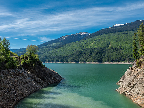 The muddier waters of a side stream meet the aqua colored Kinbasket Reservoir.
