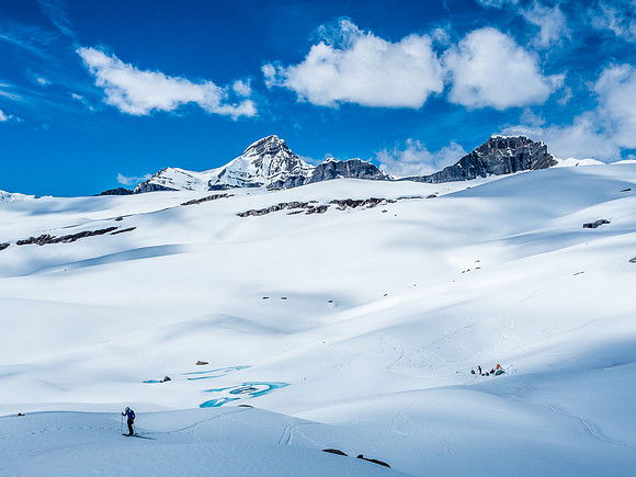 Josh skis up to my vantage point with our camp below.