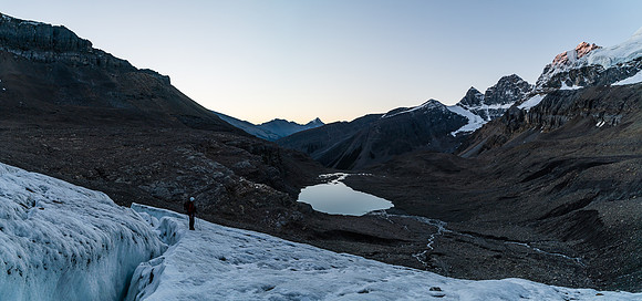 Coming up the lower glacier - Woolley Tarn is glass behind us and Engelhard is catching morning alpine glow at upper right.