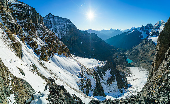 Steven and Ben follow me across the snow slope to the rising, narrow gully that gives access to the ledge traverse.
