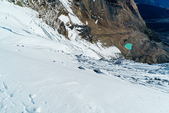 The exposure down the east face of Woolley while descending the arete is pretty cool. Woolley tarn is 1200 meters below with our bivy to it's right.