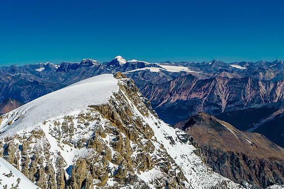 summit of Diadem Peak and clearly shows that the rocky point just to the right of the highest snow bump is the highest point.