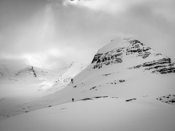 The terrain on the Robson Glacier is huge. We are off the glacier and unroped here as Ben follows me up Rearguard's lower snow slope with Mount Waffl in the background.