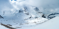 This is looking back at Waffl with The Helmet and Robson starting to show through the clouds and the Berg Glacier at right.