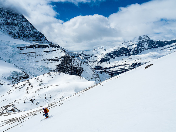Ben skis down Rearguard's SW face with Whitehorn Mountain in the far distance and the upper Berg Glacier at left.