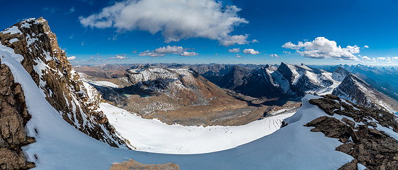 The exposure off the summit is severe to the east. Bertram Lake in the distance at center.