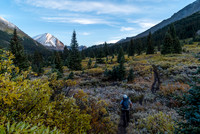 Eric marches off through frost-tinged shrubbery that's also turning into its brilliant fall coat.