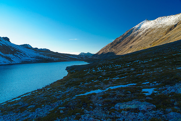 Passing by a tarn at Cline Pass.
